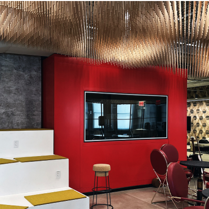 Modern office interior with unique ceiling design and vibrant red wall.