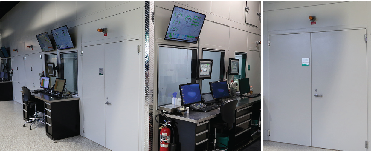Control room with monitors, equipment, and secure access doors.